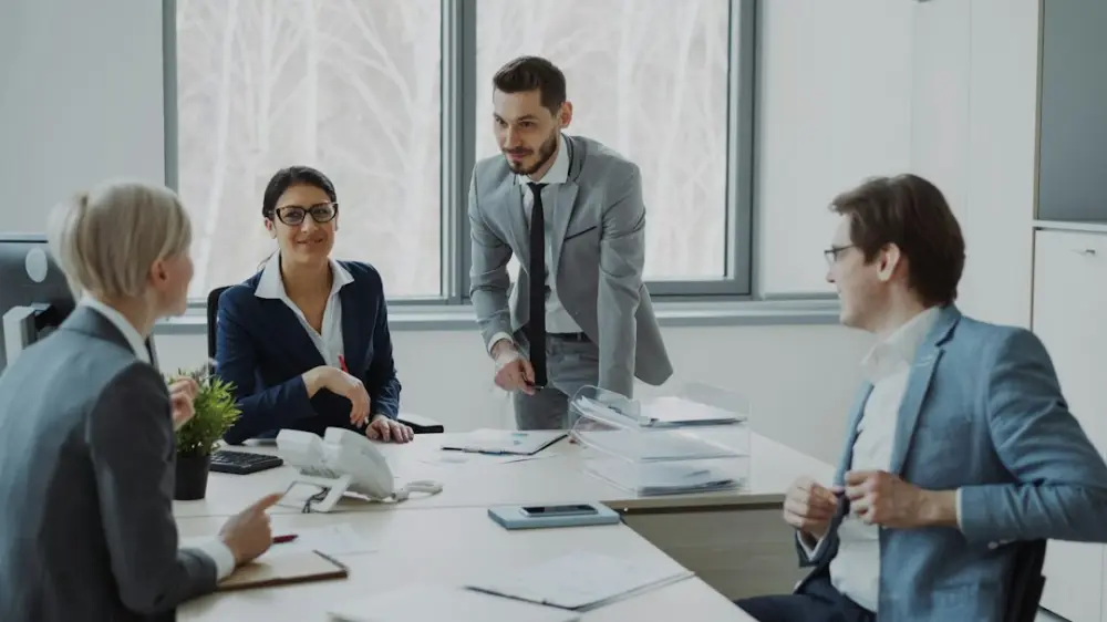 Business professionals collaborating around a conference table, illustrating CMI courses